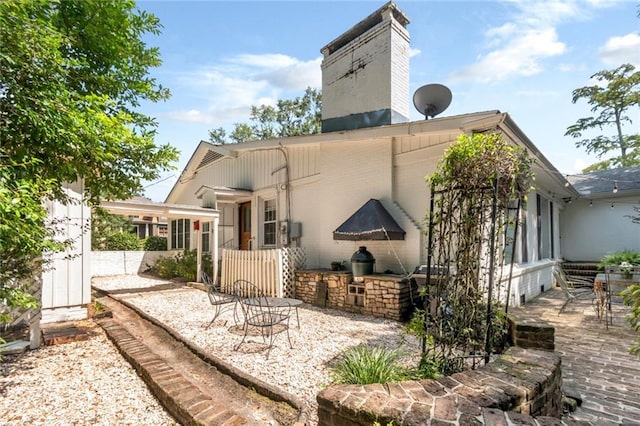 rear view of house featuring a patio and area for grilling