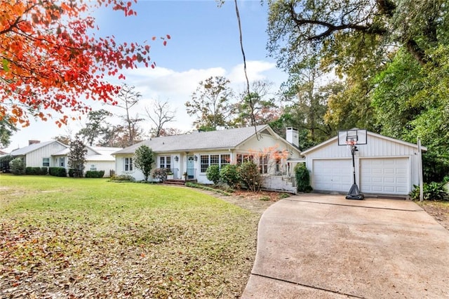 ranch-style home featuring a garage, an outbuilding, and a front lawn