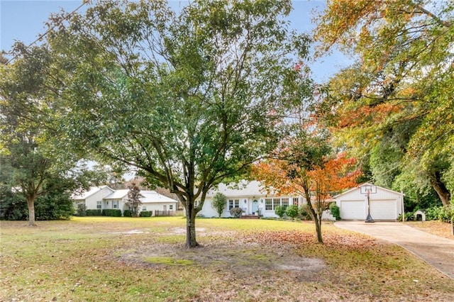 view of front facade featuring a front yard, an outbuilding, and a garage