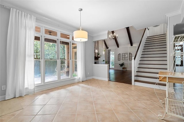 interior space featuring a chandelier, a healthy amount of sunlight, and vaulted ceiling with beams