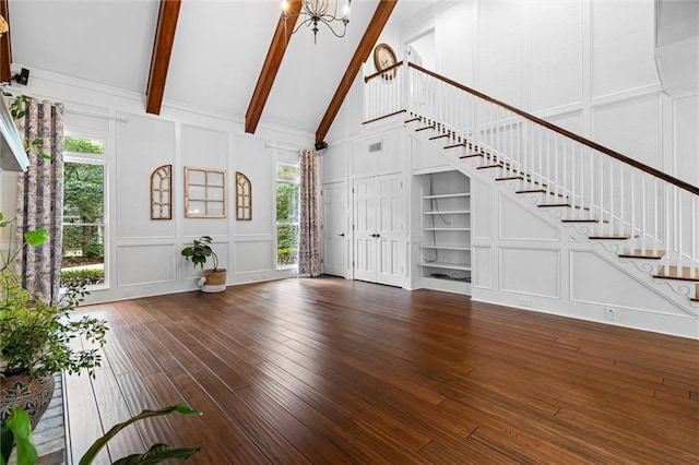 unfurnished living room with high vaulted ceiling, built in shelves, plenty of natural light, and beamed ceiling