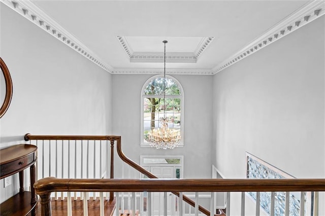 staircase featuring ornamental molding and an inviting chandelier