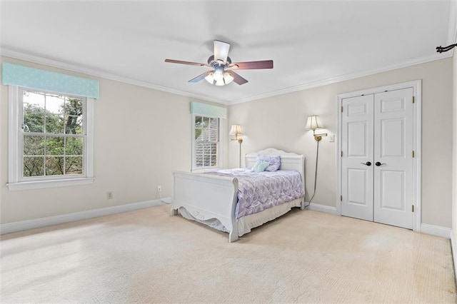 bedroom with ceiling fan, light carpet, a closet, and ornamental molding