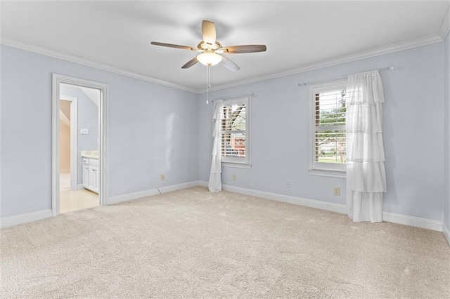 carpeted empty room with ceiling fan and ornamental molding