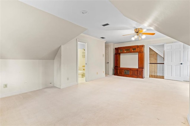 additional living space featuring ceiling fan, lofted ceiling, and light colored carpet