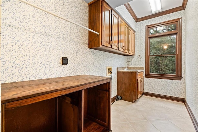 clothes washing area with washer hookup, cabinets, sink, and crown molding