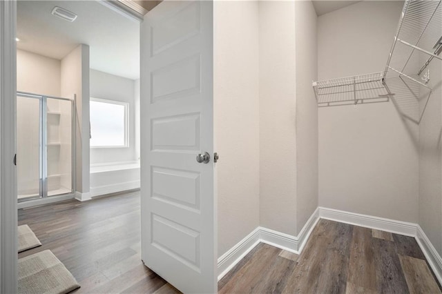 walk in closet featuring hardwood / wood-style floors