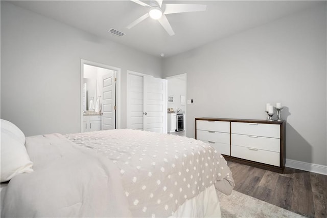 bedroom with connected bathroom, ceiling fan, and dark wood-type flooring