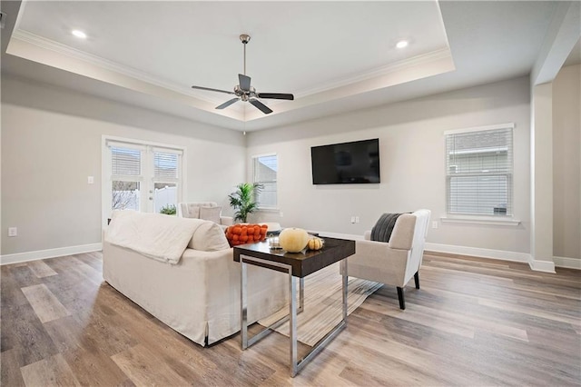 living room with ceiling fan, french doors, crown molding, and light hardwood / wood-style flooring