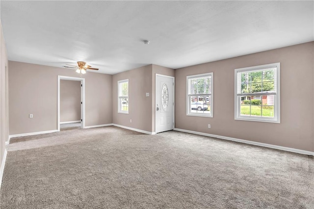 unfurnished room featuring baseboards, a ceiling fan, and carpet flooring