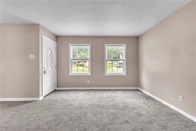 foyer with carpet flooring and baseboards