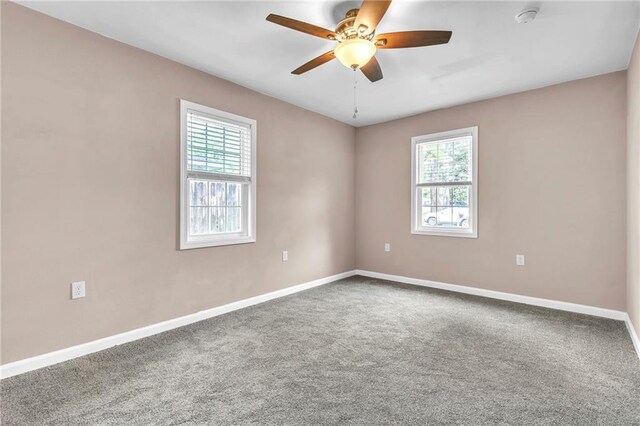 spare room with baseboards, carpet, and ceiling fan