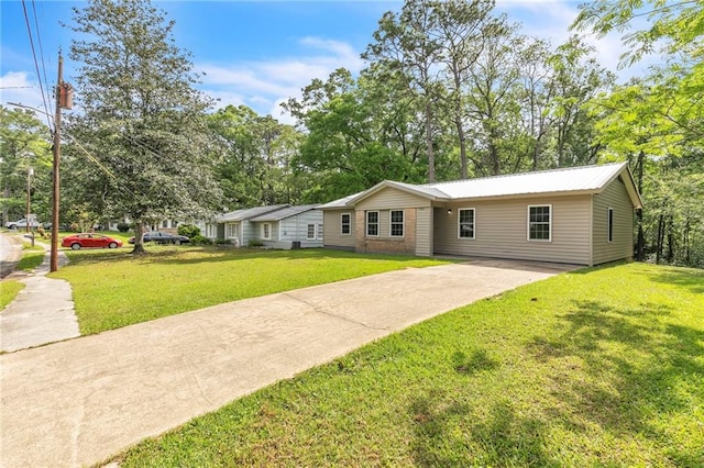 single story home featuring concrete driveway and a front yard