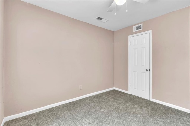 carpeted empty room featuring baseboards, visible vents, and ceiling fan
