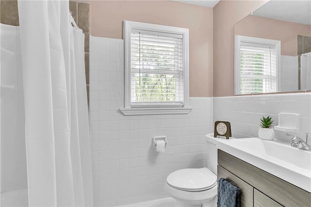 full bathroom featuring a wealth of natural light, toilet, curtained shower, and tile walls