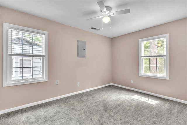 empty room with baseboards, carpet flooring, visible vents, and plenty of natural light