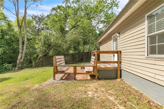 view of yard with fence and a wooden deck