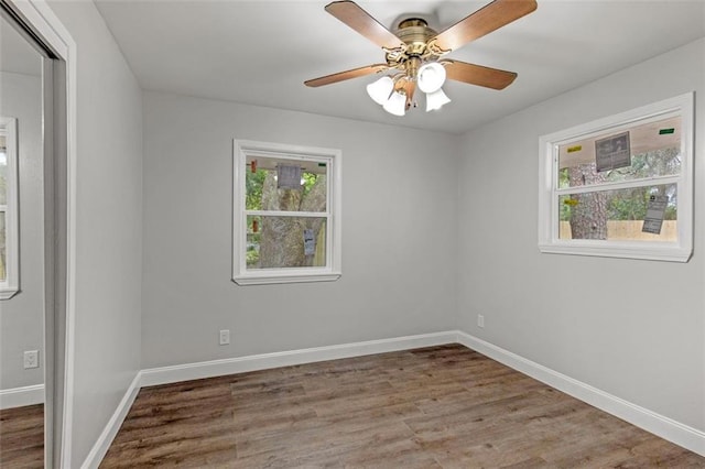 spare room featuring ceiling fan and dark hardwood / wood-style floors