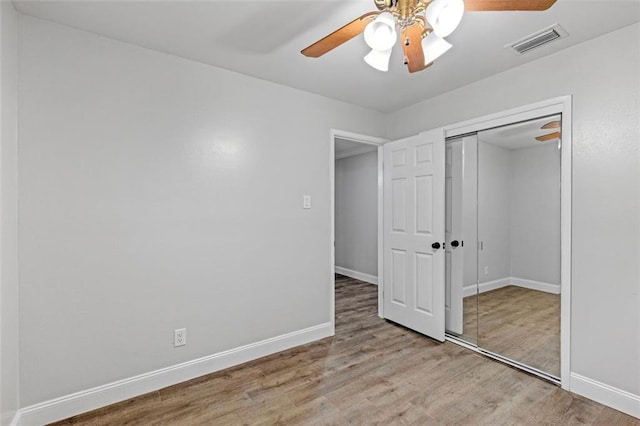 unfurnished bedroom with a closet, ceiling fan, and light wood-type flooring