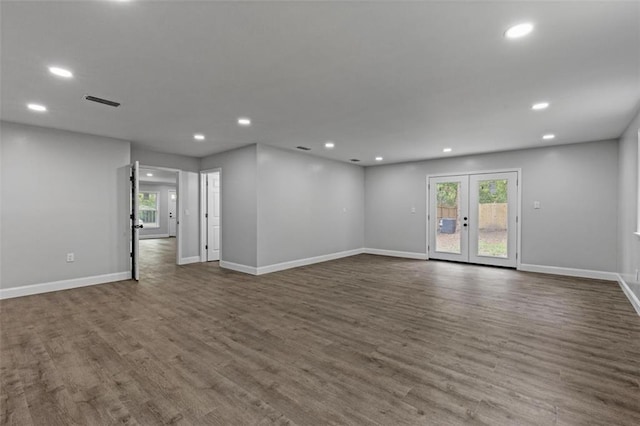 spare room with dark wood-type flooring and french doors