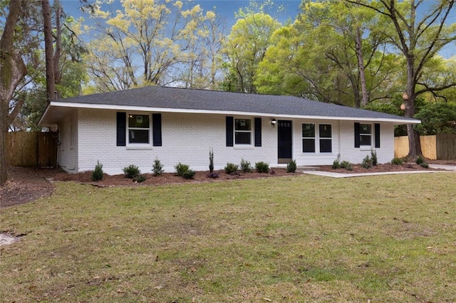 ranch-style home featuring a front yard