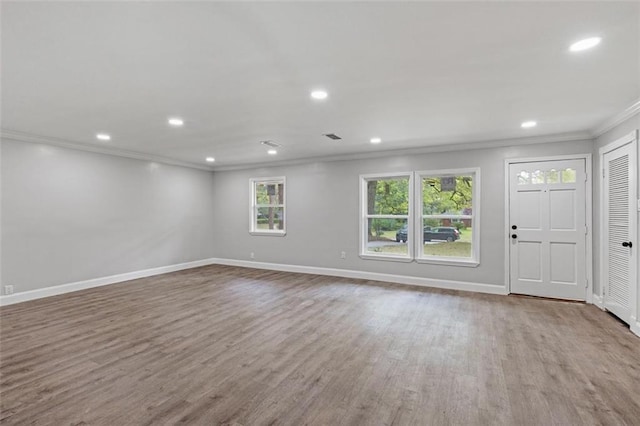 foyer featuring crown molding and hardwood / wood-style floors