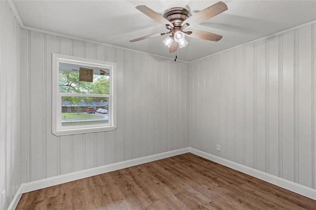 unfurnished room with ceiling fan and dark hardwood / wood-style flooring