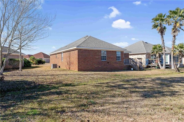 view of home's exterior with cooling unit and a yard