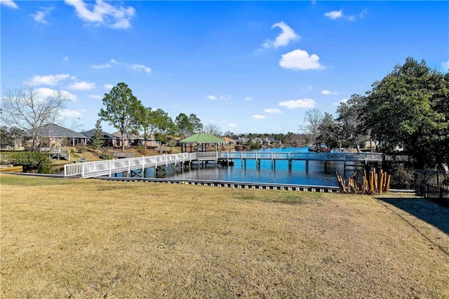 view of dock featuring a yard and a water view