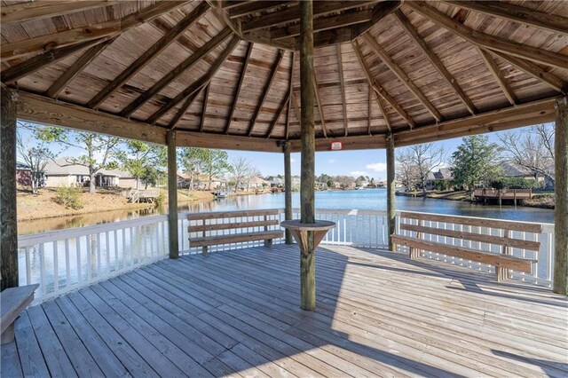 view of dock featuring a gazebo and a deck with water view