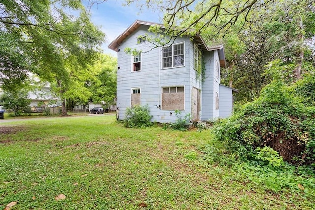 view of side of home with a lawn