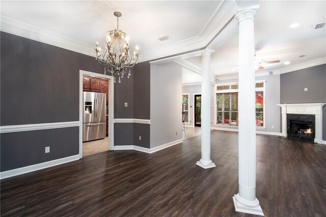 interior space featuring crown molding, decorative columns, ceiling fan with notable chandelier, a fireplace, and wood finished floors