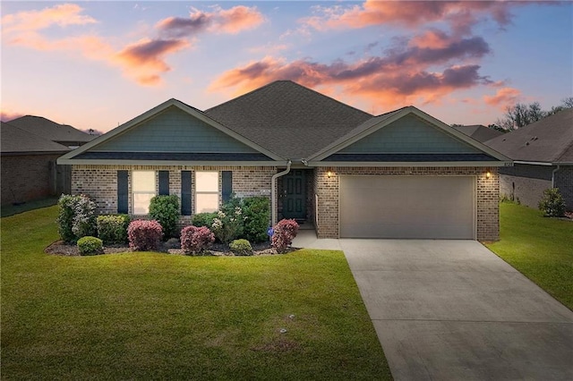 8320 Ogilvy Ct, Daphne, AL 36526 - view of front of home featuring a lawn, a garage, driveway, and brick siding