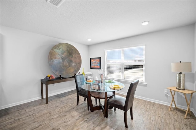 8320 Ogilvy Ct, Daphne, AL 36526 - dining area with a textured ceiling, recessed lighting, baseboards, wood finished floors, and visible vents