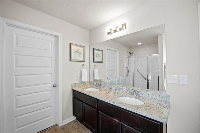 8320 Ogilvy Ct, Daphne, AL 36526 - full bathroom featuring wood finished floors, a sink, a stall shower, and double vanity