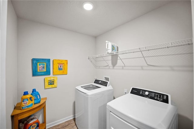 8320 Ogilvy Ct, Daphne, AL 36526 - clothes washing area featuring laundry area, washer and clothes dryer, baseboards, and wood finished floors