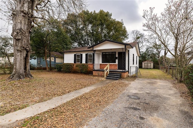 bungalow-style house with a shed