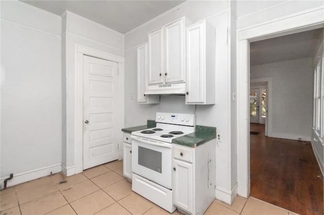 kitchen with white cabinetry, white electric stove, and light tile patterned floors