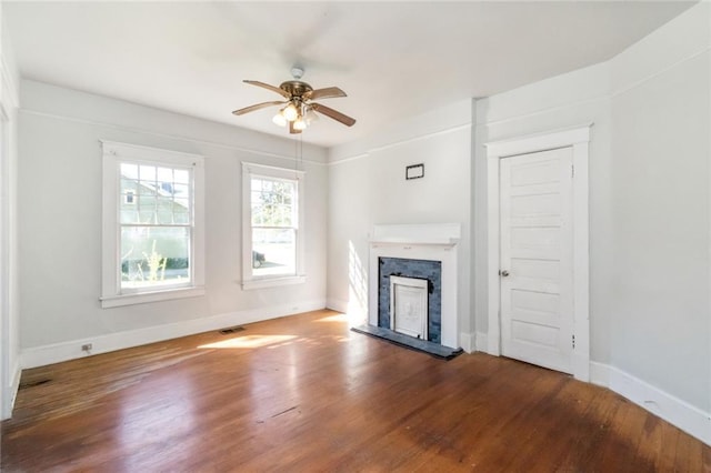 unfurnished living room with hardwood / wood-style floors and ceiling fan