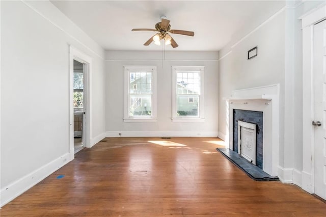 unfurnished living room with wood-type flooring and ceiling fan