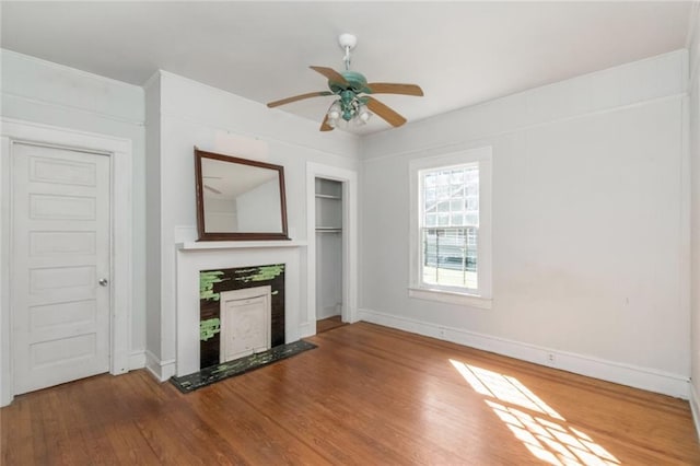 unfurnished living room with hardwood / wood-style flooring and ceiling fan