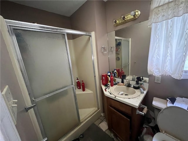 5470 Robert Jefferson Dr E, Theodore, AL 36582 - bathroom with vanity, a stall shower, toilet, and tile patterned flooring