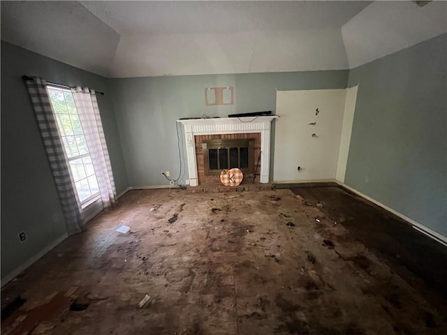 5470 Robert Jefferson Dr E, Theodore, AL 36582 - unfurnished living room featuring vaulted ceiling, a brick fireplace, and baseboards