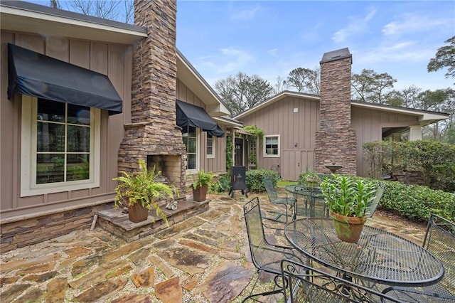 view of patio / terrace with outdoor dining space and a fireplace