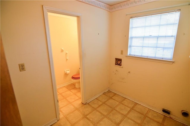 interior space featuring light floors, baseboards, laundry area, and hookup for a washing machine
