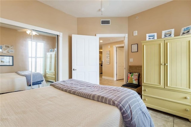 bedroom with light tile patterned flooring, visible vents, and a ceiling fan