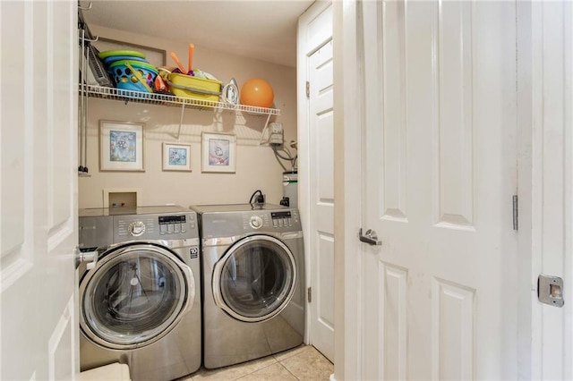 laundry room with tile patterned floors and independent washer and dryer