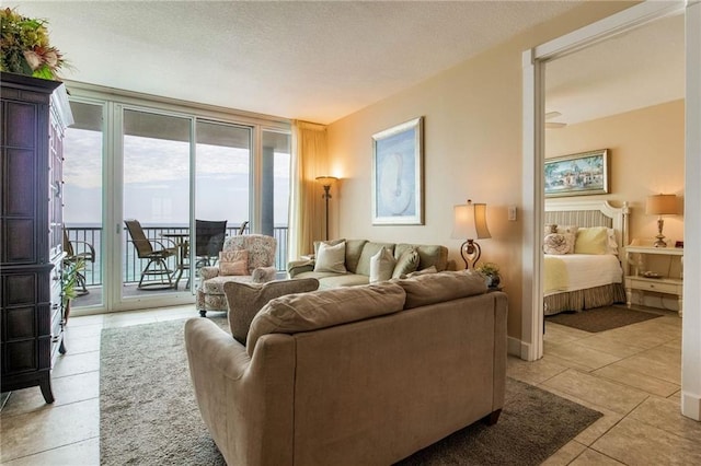 living room featuring light tile patterned flooring and a textured ceiling