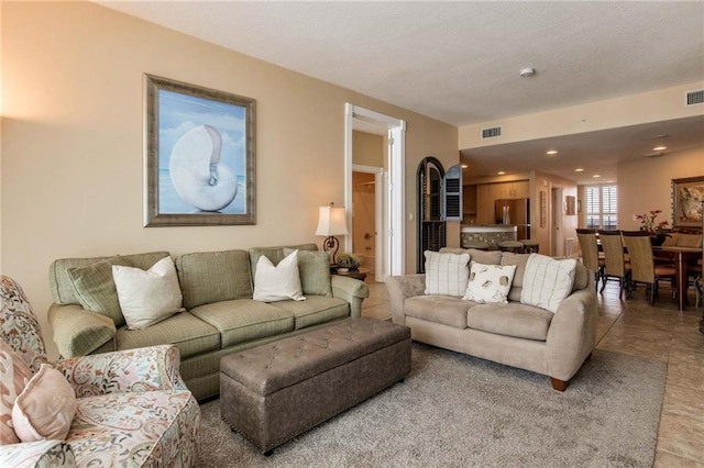 living area featuring visible vents and recessed lighting