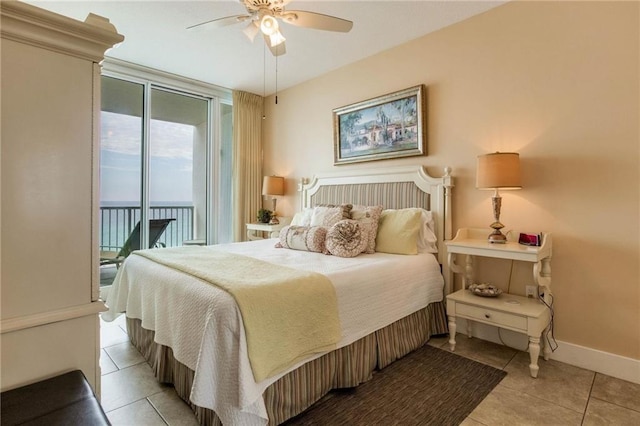 bedroom with light tile patterned floors, a ceiling fan, baseboards, access to exterior, and floor to ceiling windows